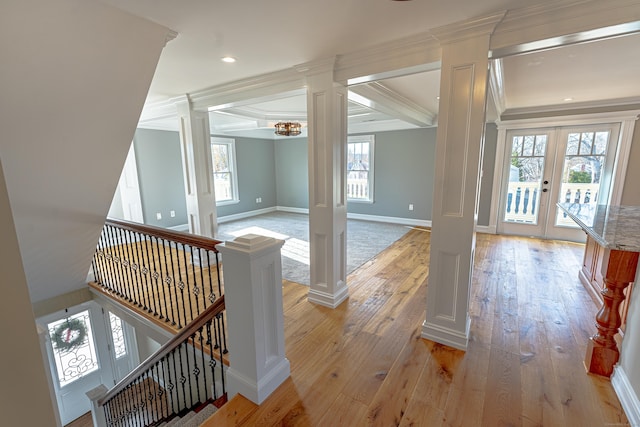 additional living space with decorative columns, french doors, light wood finished floors, and baseboards