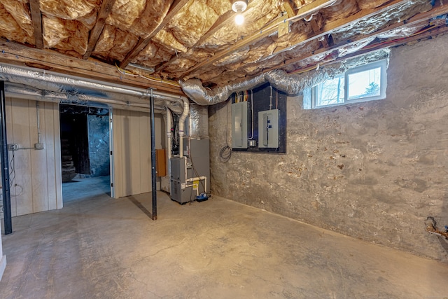 below grade area featuring electric panel and heating unit