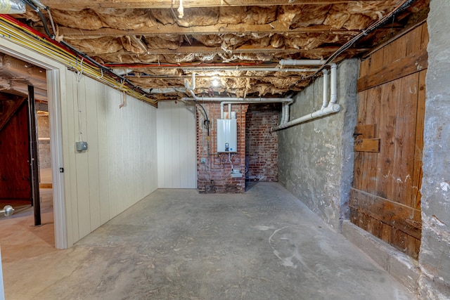 unfinished below grade area featuring tankless water heater