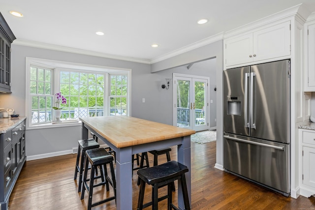 11 Thomas Rd, Westport, CT 06880 - kitchen featuring high end fridge, ornamental molding, a breakfast bar area, wood counters, and dark wood finished floors
