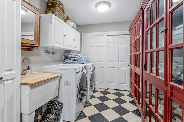 11 Thomas Rd, Westport, CT 06880 - laundry room featuring cabinet space, washing machine and clothes dryer, and light floors