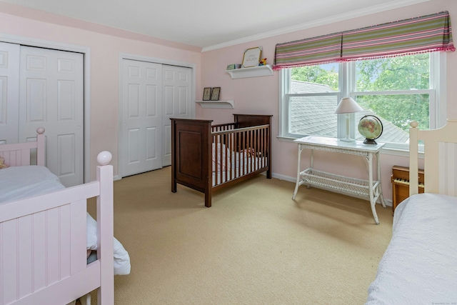 11 Thomas Rd, Westport, CT 06880 - bedroom featuring multiple closets, crown molding, carpet, and baseboards