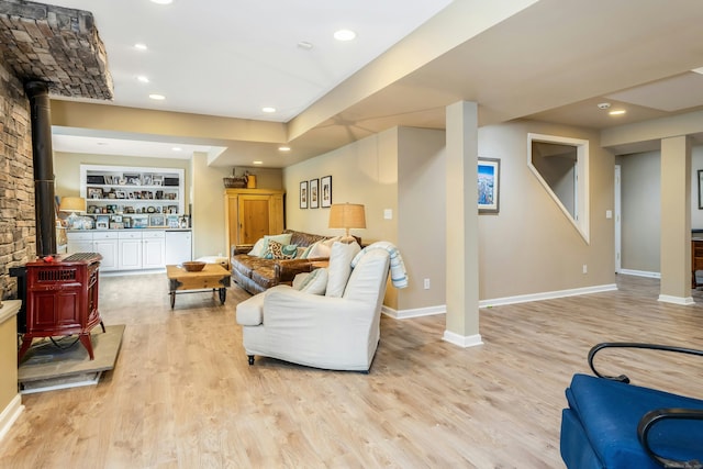11 Thomas Rd, Westport, CT 06880 - living area with a wood stove, baseboards, wood finished floors, recessed lighting, and bar area