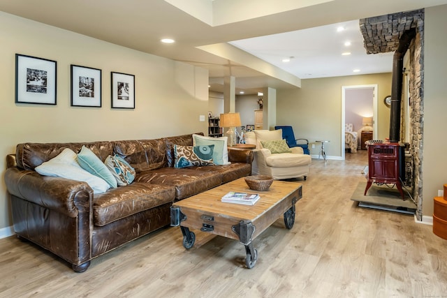 11 Thomas Rd, Westport, CT 06880 - living room with a wood stove, light wood finished floors, baseboards, and recessed lighting