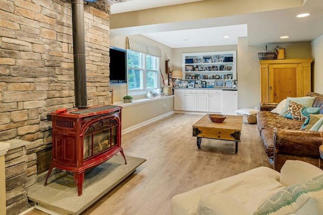 11 Thomas Rd, Westport, CT 06880 - living area with a wood stove, light wood finished floors, baseboards, and recessed lighting