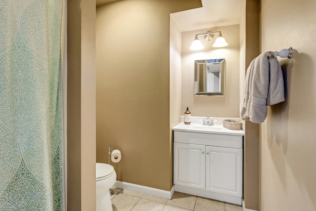 11 Thomas Rd, Westport, CT 06880 - bathroom with toilet, vanity, baseboards, and tile patterned flooring