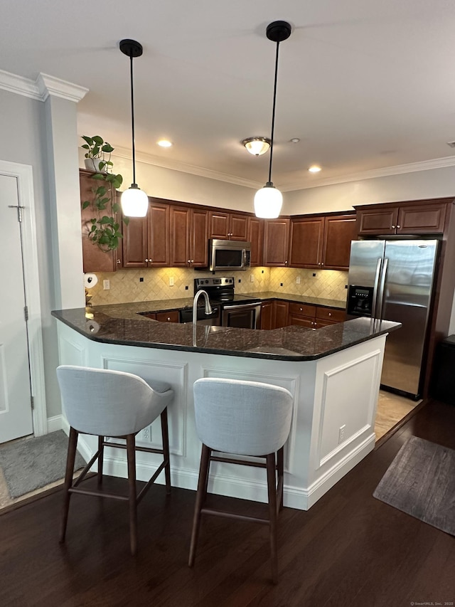 95 S Ridge Ln Unit D201, Berlin, CT 06037 - kitchen with appliances with stainless steel finishes, crown molding, a peninsula, tasteful backsplash, and dark stone counters