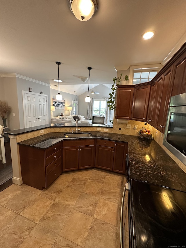 95 S Ridge Ln Unit D201, Berlin, CT 06037 - kitchen featuring stainless steel microwave, a sink, pendant lighting, ornamental molding, and dark stone counters