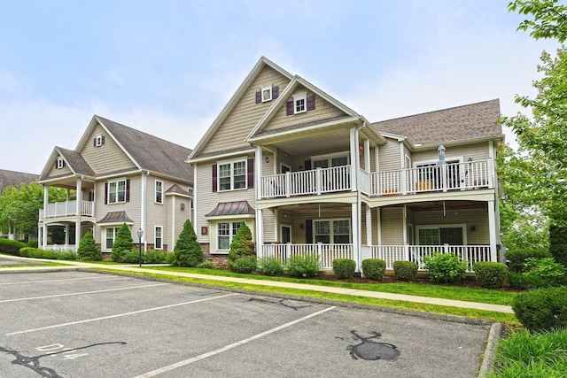 95 S Ridge Ln Unit D201, Berlin, CT 06037 - view of front of home featuring a balcony, uncovered parking, a porch, and roof with shingles