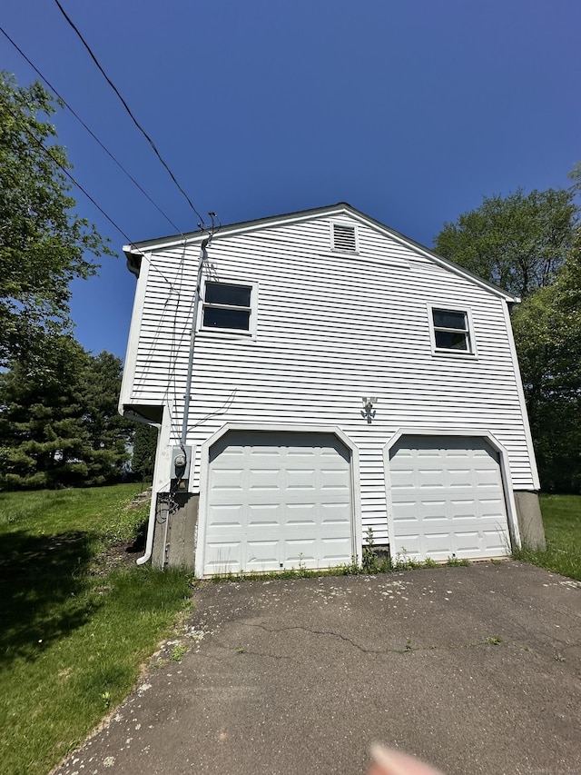 48 Canterbury Dr, Durham, CT 06422 - view of side of property with an attached garage and asphalt driveway