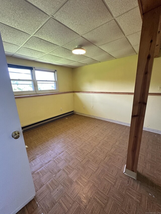 48 Canterbury Dr, Durham, CT 06422 - below grade area with a baseboard heating unit, a paneled ceiling, and baseboards