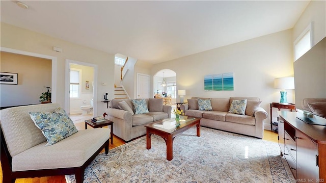 196 Jefferson St, Stratford, CT 06615 - living area with stairway, arched walkways, and light wood-style floors