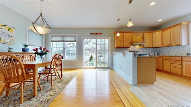 196 Jefferson St, Stratford, CT 06615 - kitchen with custom range hood, light wood-style floors, backsplash, baseboards, and decorative light fixtures