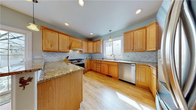 196 Jefferson St, Stratford, CT 06615 - kitchen with appliances with stainless steel finishes, custom range hood, a sink, a peninsula, and decorative backsplash