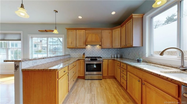 196 Jefferson St, Stratford, CT 06615 - kitchen featuring stainless steel gas stove, a sink, plenty of natural light, a peninsula, and recessed lighting