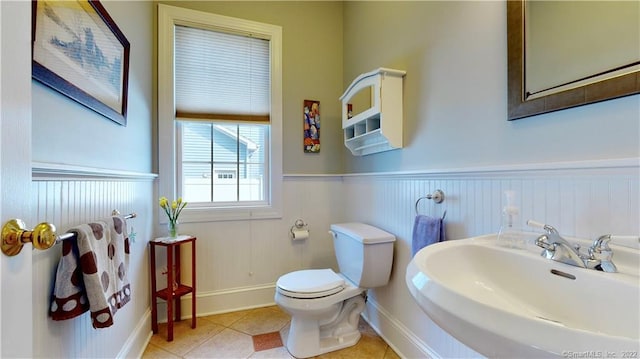 196 Jefferson St, Stratford, CT 06615 - half bath with a sink, a wainscoted wall, toilet, tile patterned flooring, and baseboards