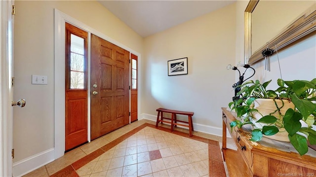 196 Jefferson St, Stratford, CT 06615 - foyer with baseboards, light tile patterned flooring, and inlaid floor details