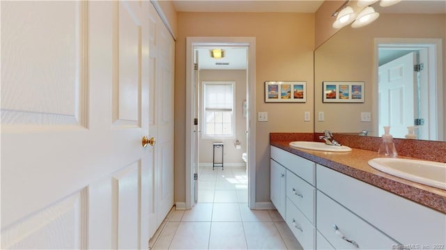 196 Jefferson St, Stratford, CT 06615 - bathroom featuring tile patterned flooring, double vanity, toilet, and baseboards