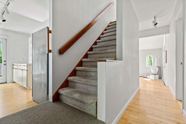 18 Charles St, Groton, CT 06355 - stairs featuring track lighting, hardwood / wood-style flooring, and baseboard heating