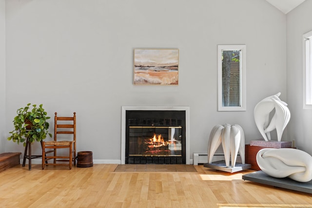 18 Charles St, Groton, CT 06355 - detailed view of wood finished floors, a fireplace with flush hearth, and baseboard heating