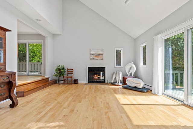 18 Charles St, Groton, CT 06355 - sitting room featuring wood-type flooring, a fireplace with flush hearth, healthy amount of natural light, high vaulted ceiling, and baseboard heating