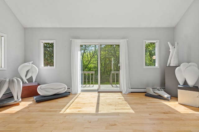 18 Charles St, Groton, CT 06355 - doorway to outside with plenty of natural light, wood finished floors, lofted ceiling, and a baseboard radiator