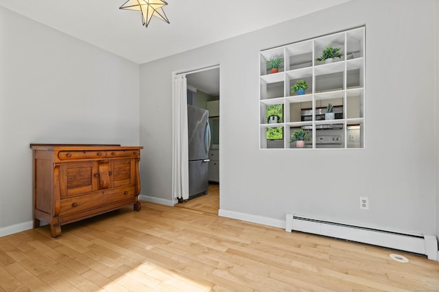 18 Charles St, Groton, CT 06355 - empty room featuring a baseboard radiator, wood finished floors, and baseboards