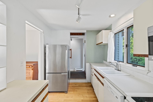 18 Charles St, Groton, CT 06355 - kitchen featuring freestanding refrigerator, white dishwasher, a sink, a baseboard radiator, and light wood-style flooring