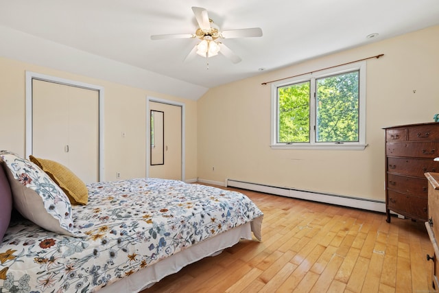 18 Charles St, Groton, CT 06355 - bedroom with a baseboard radiator, light wood-style flooring, vaulted ceiling, a ceiling fan, and multiple closets