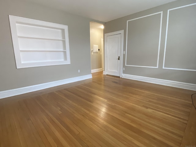 139 Fountain St Apt B9, New Haven, CT 06515 - empty room featuring built in shelves, baseboards, and wood finished floors