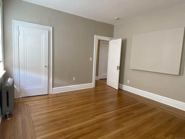 139 Fountain St Apt B9, New Haven, CT 06515 - unfurnished bedroom featuring radiator heating unit, wood finished floors, and baseboards