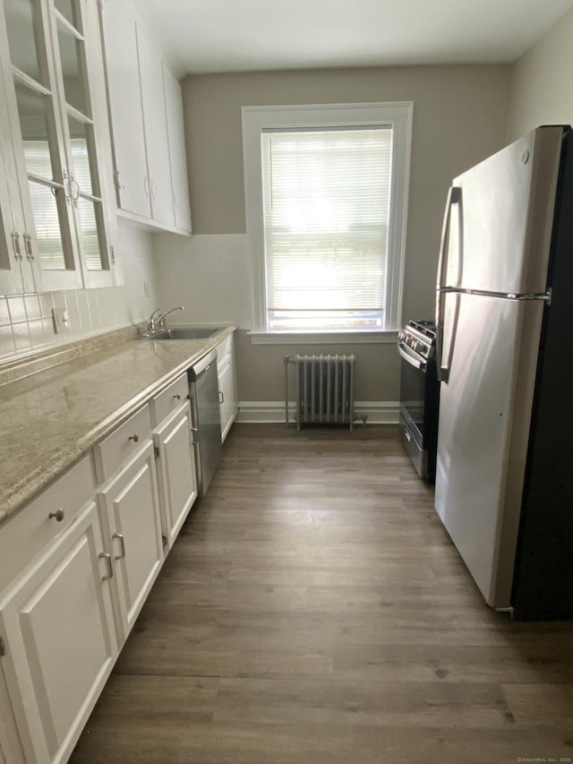 139 Fountain St Apt B9, New Haven, CT 06515 - kitchen with stainless steel appliances, radiator, white cabinets, wood finished floors, and baseboards