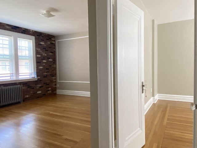 139 Fountain St Apt B9, New Haven, CT 06515 - corridor featuring radiator, wood finished floors, baseboards, and brick wall