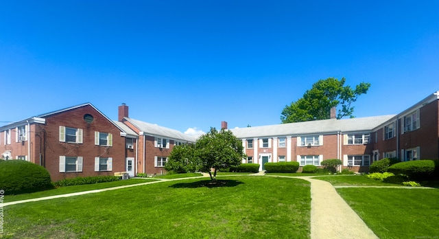 view of home's community featuring a yard
