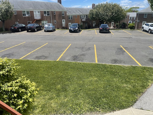 uncovered parking lot with a residential view