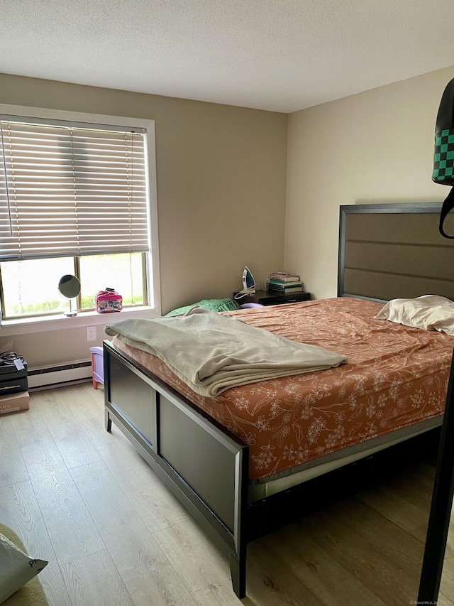 130 Coe Ave Unit 81, East Haven, CT 06512 - bedroom featuring light wood-style flooring and a baseboard radiator