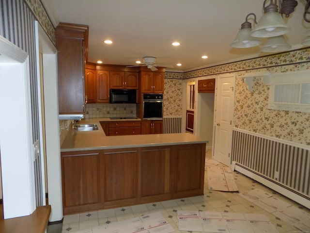 kitchen with black appliances, wallpapered walls, a baseboard radiator, light flooring, and a peninsula