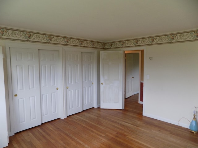 unfurnished bedroom with light wood-type flooring and baseboards