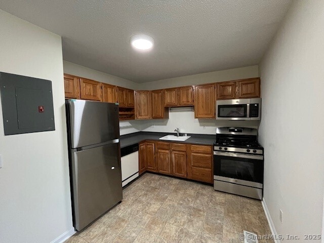 346 Prospect Ave Unit 3, New Haven, CT 06512 - kitchen with stainless steel appliances, electric panel, dark countertops, a sink, and brown cabinetry