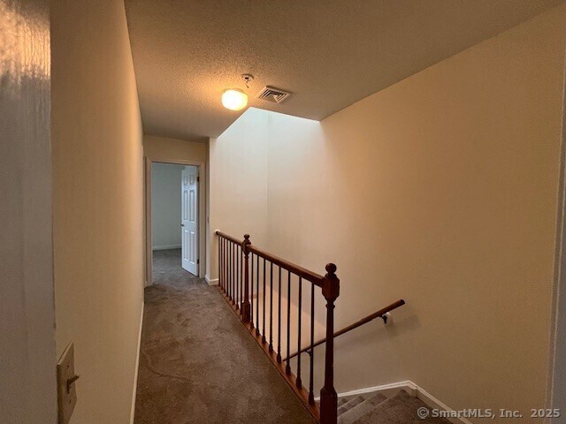 346 Prospect Ave Unit 3, New Haven, CT 06512 - staircase featuring carpet, a textured ceiling, and baseboards