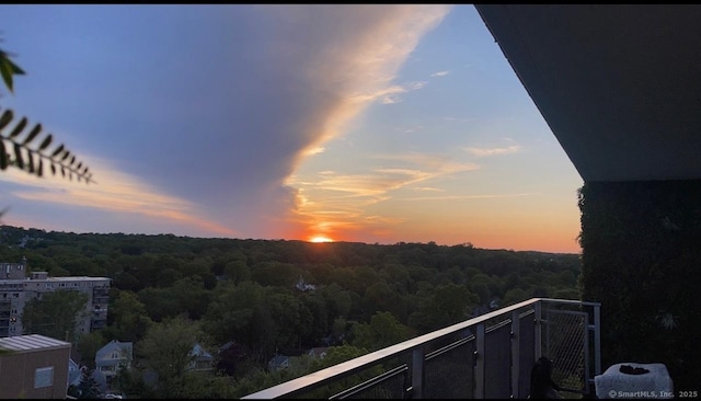 2370 N Ave Unit 12G, Bridgeport, CT 06604 - balcony at dusk featuring a wooded view