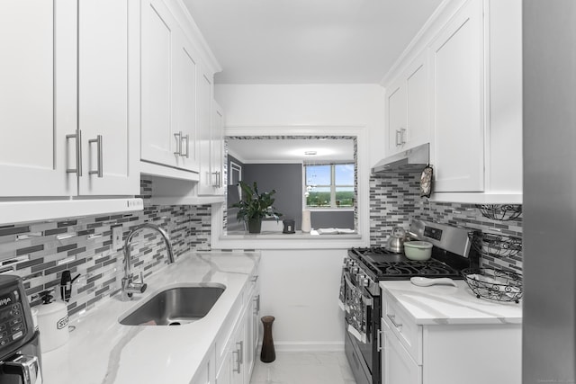 2370 N Ave Unit 12G, Bridgeport, CT 06604 - kitchen with gas range, a sink, under cabinet range hood, and white cabinetry