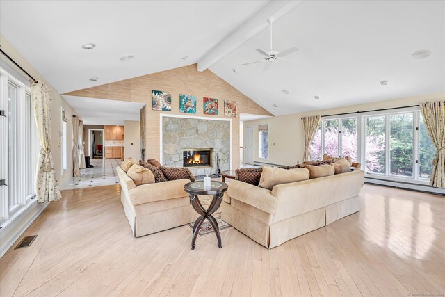 81 Georges Ln, Monroe, CT 06468 - living room featuring light wood-style floors, a ceiling fan, a fireplace, beam ceiling, and high vaulted ceiling