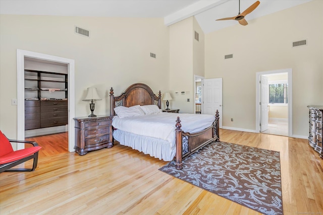 81 Georges Ln, Monroe, CT 06468 - bedroom with wood finished floors, high vaulted ceiling, beamed ceiling, a walk in closet, and ensuite bath
