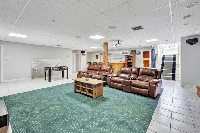81 Georges Ln, Monroe, CT 06468 - tiled living room featuring stairs, baseboards, and a drop ceiling