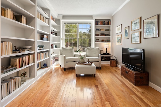 5 Harwich Ln Unit 5, West Hartford, CT 06117 - living area featuring crown molding, hardwood / wood-style floors, built in features, and baseboards