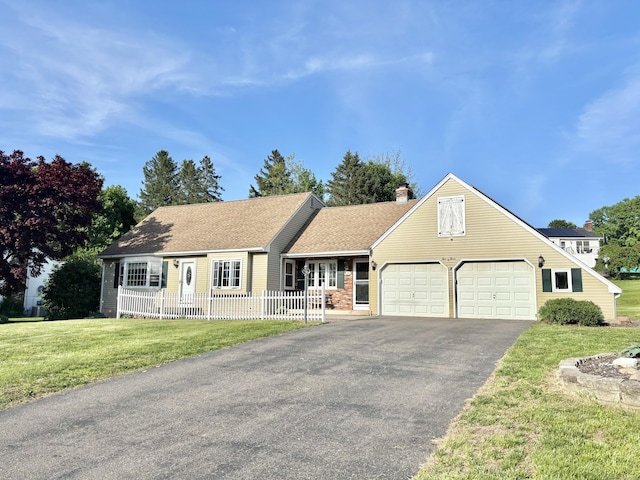 23 Strawberry Ln, Manchester, CT 06040 - view of front of house featuring a garage, driveway, and a chimney
