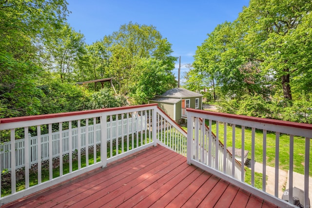 29 E Cliff St, Norwich, CT 06360 - wooden terrace featuring an outdoor structure, a storage unit, and a lawn