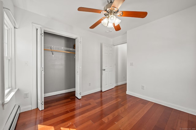 29 E Cliff St, Norwich, CT 06360 - unfurnished bedroom with baseboard heating, wood finished floors, a closet, and baseboards