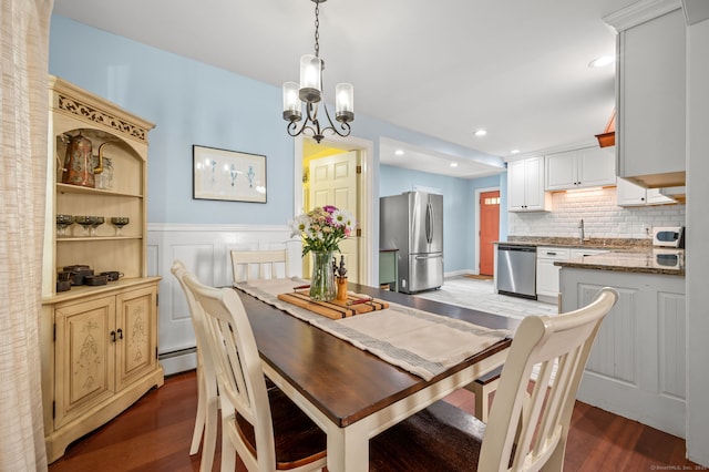 29 E Cliff St, Norwich, CT 06360 - dining room with dark wood-type flooring, a wainscoted wall, a chandelier, recessed lighting, and baseboard heating